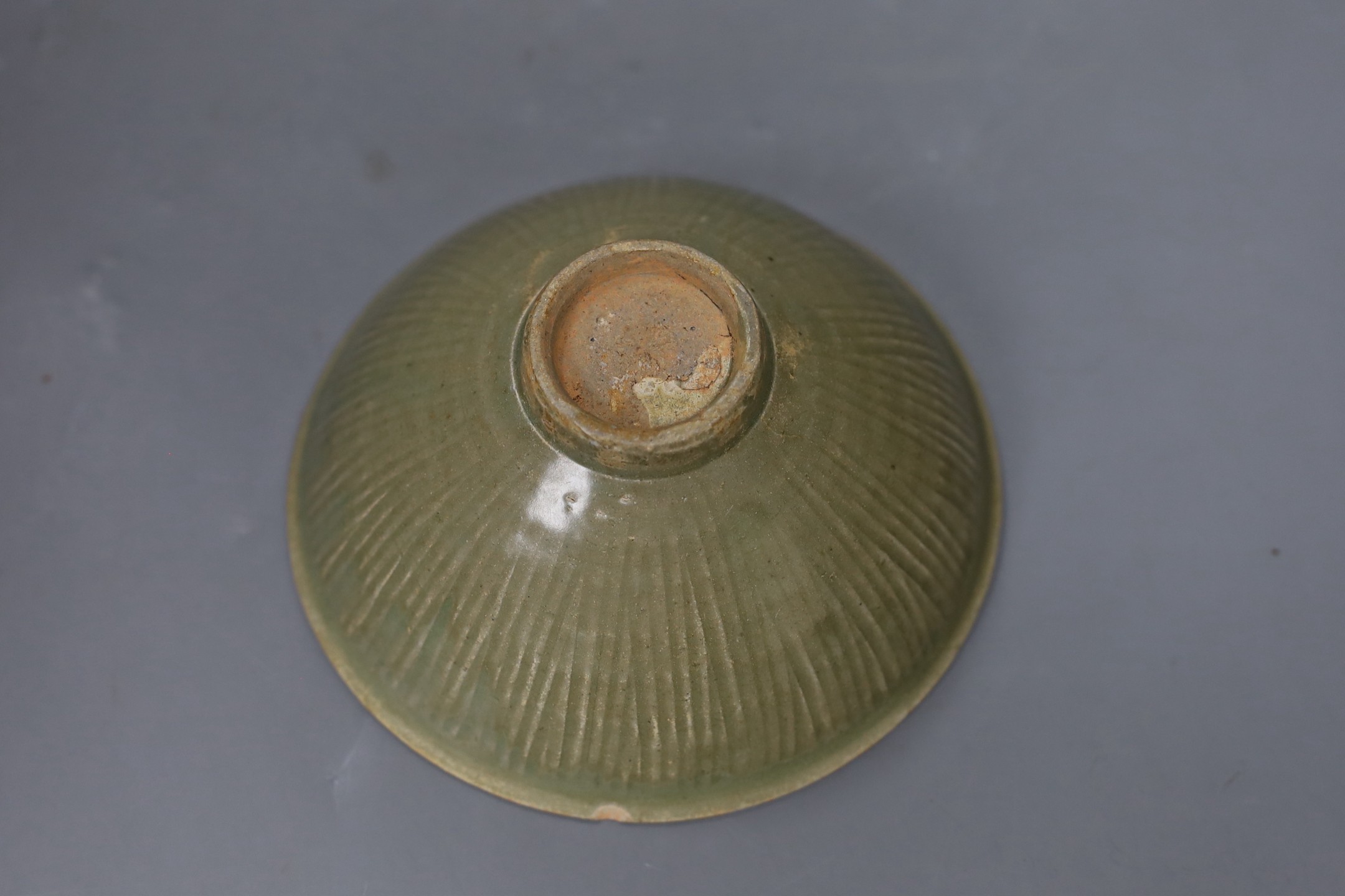 A Chinese carved Yaozhou celadon bowl, Northern Song Dynasty, 15.5cms high